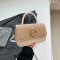 Beige vierkante tas met stro-textuur en gouden M-gesp in de hand gehouden - Wit