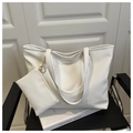 Close-up of white tote bag set with matching zipper pouch on a black leather chair - White