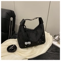 Detail of black floral textured handbag with 3D flower accent and drawstring pearls - Black
