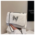 Detail of white wrinkled leather bag with metallic butterfly and silver chain strap - White