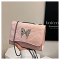Detail of pink pleated leather bag with silver butterfly metal ornament and chain strap - Pink