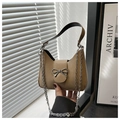 Detail of khaki baguette bag with silver bow clasp and metallic chain strap - Khaki