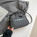 Chic black underarm bag with bow detail and golden hardware for women's fashion - Black
