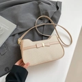 Chic beige woven shoulder bag with leather bow detail and golden metal hardware accent - Khaki