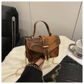 Detailed macro of the vintage brown snake skin textured bag with golden metal U-shaped buckle - Brown