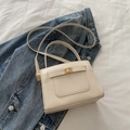 Chic beige structured handbag with cross-grain texture and elegant gold metallic clasp - White