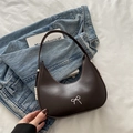 Dark brown half-moon hobo bag with a silver metallic bow and smooth PU leather finish - Brown