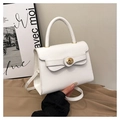 Detail of white faux leather handbag showing golden circular lock and fine texture - White