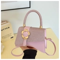 Detail of pink leather handbag with glittery woven texture and gold flower clasp - Pink