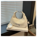 Detail of cream crescent bag with silver metal bow and fine textured synthetic leather - White