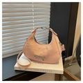 Close-up of pink crinkled leather handbag featuring a silver bow accent and metal zipper - Pink