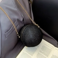 Black spherical sequin evening bag with gold chain strap on a designer suit jacket - Black