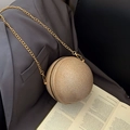 Spherical evening bag with gold glitter finish and metallic chain strap on gray blazer - Khaki