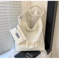 Detail of off-white corduroy tote bag set with golden letter embroidery and texture - White