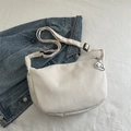 Detail of white waffle corduroy half-moon bag with adjustable strap and cute puppy charm - White