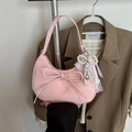 Chic pink crescent bag with bow detail and pearl charms in a stylish handheld shot - Pink With Pendant