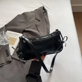 Bolso baguette minimalista de charol negro con lazos laterales y remaches plateados - Negro
