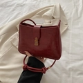 Red croc-pattern crossbody bag with gold buckle and stylish knot detail on strap - Red