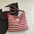 Red and white striped knit tote bag featuring a red lace bow and stylish shoulder strap - Red