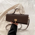 Brown woven leather baguette bag with a gold lock and adjustable shoulder strap - Brown