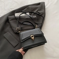 Fashionable black faux leather handbag with elegant gold double-ring buckle detail - Black