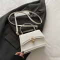 White leather handbag with golden ring buckle and adjustable shoulder strap on blazer - White