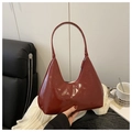 Close-up of burgundy high-gloss hobo bag with sleek zipper and elegant strap detail - Red