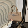 Elegant beige lychee grain leather handbag with silver metallic turn-lock and shoulder strap - Khaki