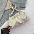 Ivory satin hobo bag with floral patterns and a scrunchie strap shown on denim - Off White