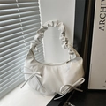 Chic cream white crescent bag with pleated cloud handle and bow details on a soft grey background - White