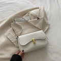 White minimalist leather baguette bag with a stylish gold sculptural clasp for women - White