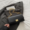 Black crocodile pattern baguette bag with chunky gold chain strap on grey blazer - Black