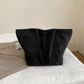 Chic black canvas tote bag with embossed lettering and spacious interior design - Black