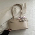 Minimalist beige baguette shoulder bag featuring a stylish bow and silver buckle - Khaki