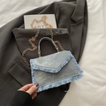 Light blue denim envelope crossbody bag with fringe trim and golden chain strap - Blue