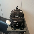 Black quilted backpack with embroidered colorful bows and a white cloud charm accessory - With Pendant / Large / Black