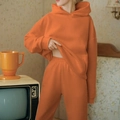 Women's casual oversized orange hoodie and jogger pants set in a vintage studio setting - 3XL / Top And Bottom / Orange