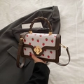 Chic white strawberry print handbag with brown woven handle and gold flower lock - Brown
