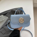 Light blue crossbody bag with woven texture flap and gold M-buckle detail - Blue