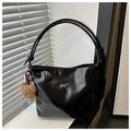 Detail of glossy black tote bag featuring a silver bow buckle and a plush bear charm - With Pendant / Black (With Charm)