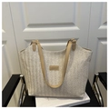 Close-up of beige woven tote bag with camel leather straps and FASHION logo tag - Khaki