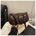 Detail of dark brown glossy leather shoulder bag with oversized silver buckle and metal eyelets - Coffee