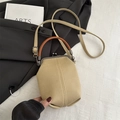 Minimalist khaki canvas bucket bag with brown leather handles and adjustable strap - Khaki