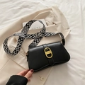 Black leather crossbody bag with broad woven strap and gold oval metal buckle decor - Black