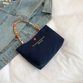 Deep blue canvas tote with colorful beaded handle and red accents in vintage style - Blue