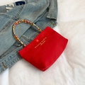 Red canvas handbag with colorful beaded handle and gold embroidery detail in a chic style - Red