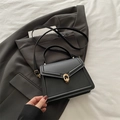 Classic black leather crossbody bag with elegant gold clasp and top handle for women - Black