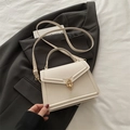 Minimalist beige crossbody handbag with elegant gold ring clasp and leather strap - White