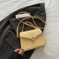Chic cream yellow crossbody square handbag with golden ring lock on black blazer - Yellow