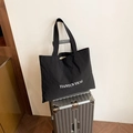 Minimalist black canvas tote bag with white TIANYUN YICAI lettering for daily travel - Black